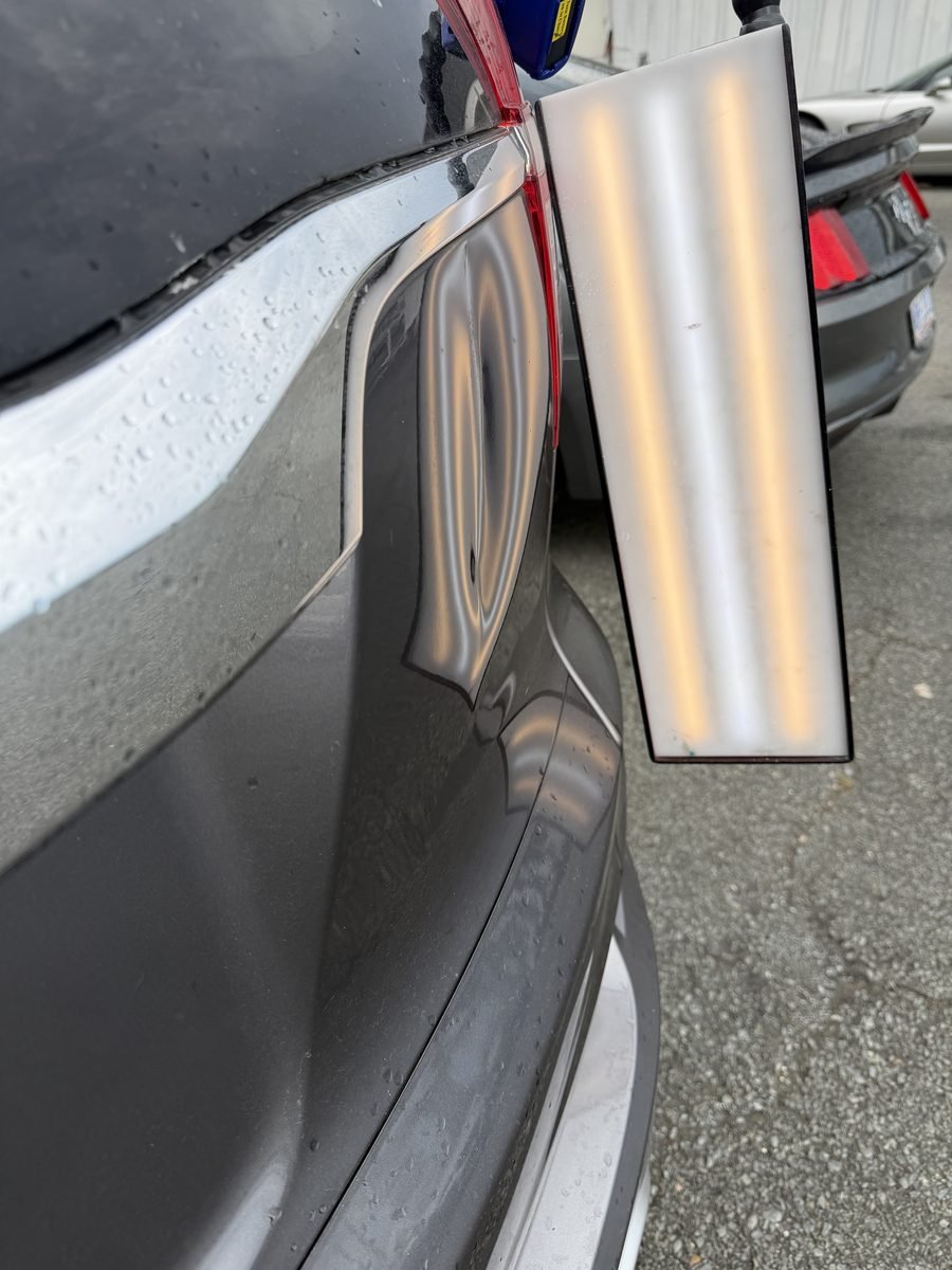 Rear quarter panel dent before paintless dent repair